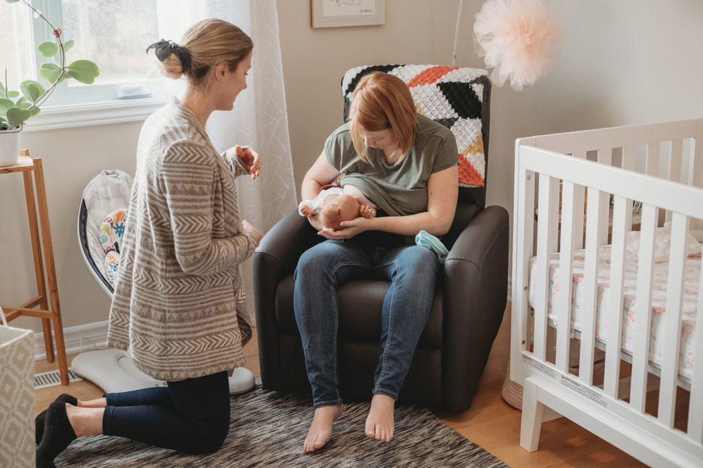 A birth professional giving a parent breastfeeding support.